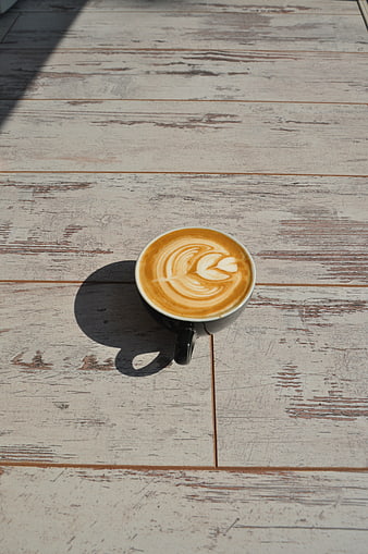 Top View of Latte Art Coffee on Rustic Wooden Table