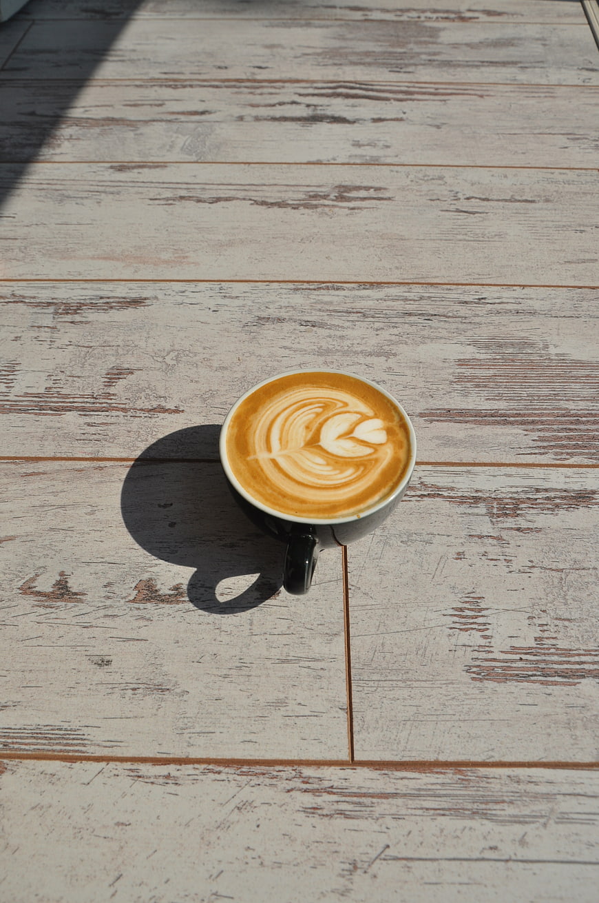 Top View of Latte Art Coffee on Rustic Wooden Table