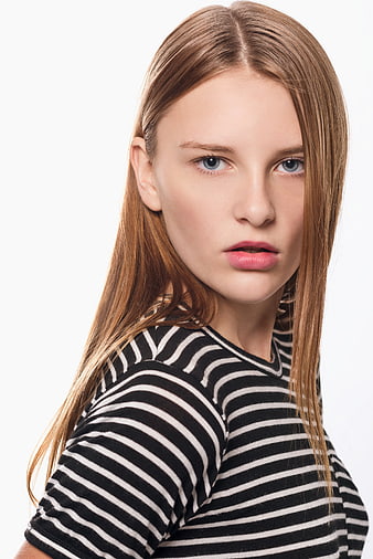 Portrait of young woman with long hair in striped shirt