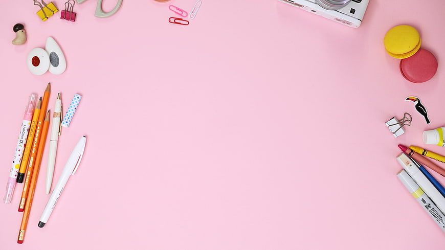 Pink flat lay stationery with macarons and camera