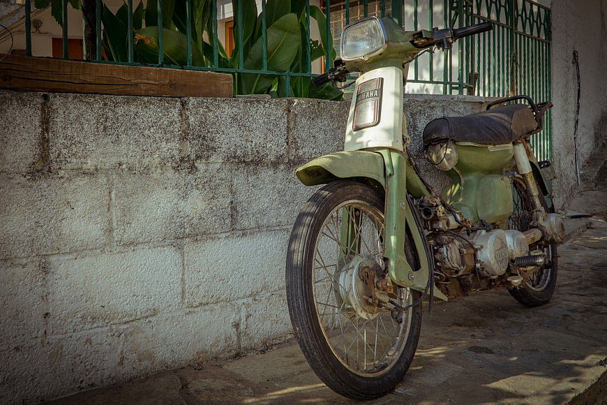 Vintage Green Yamaha Motorcycle Parked on Street