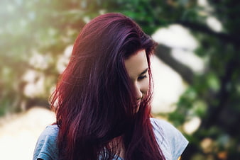 Woman with Red Hair Looking Down in Nature