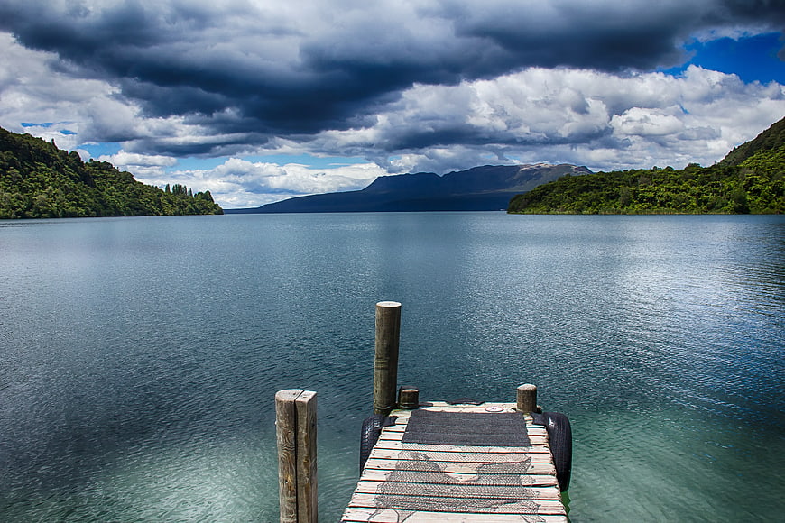 Wooden Dock on Calm Lake with Stormy Sky