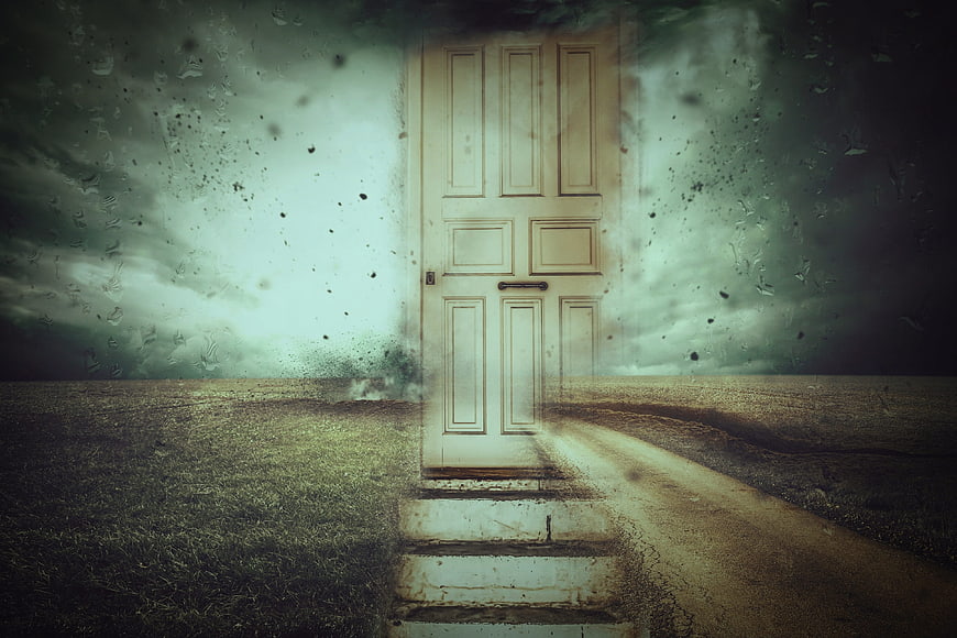 Surreal white door in a stormy landscape with rain texture