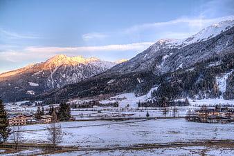 Snowy Alpine Valley with Golden Sunlit Mountain Peaks