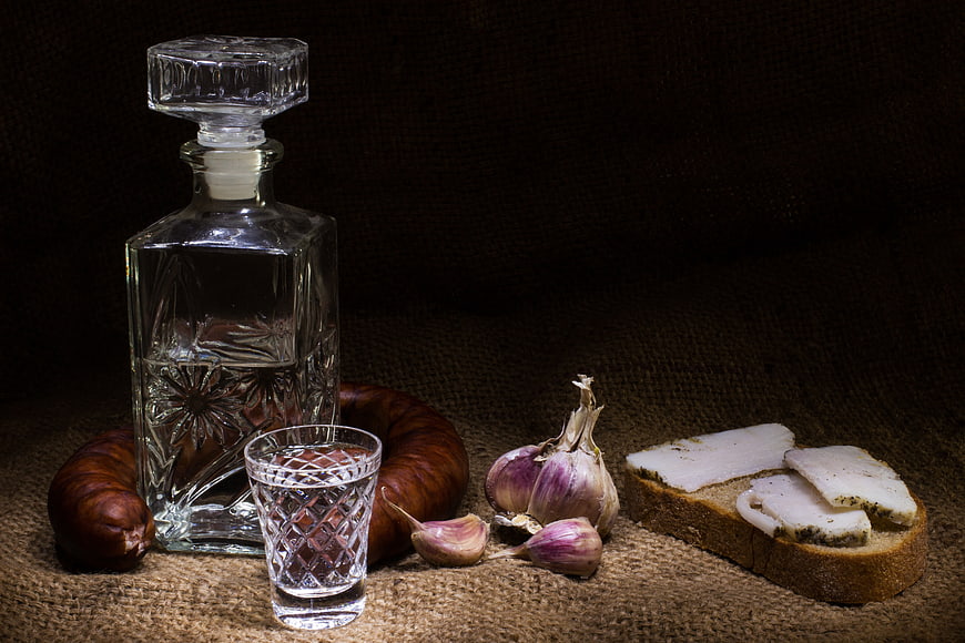 Traditional Vodka Still Life With Salo, Bread, Sausage, And Garlic