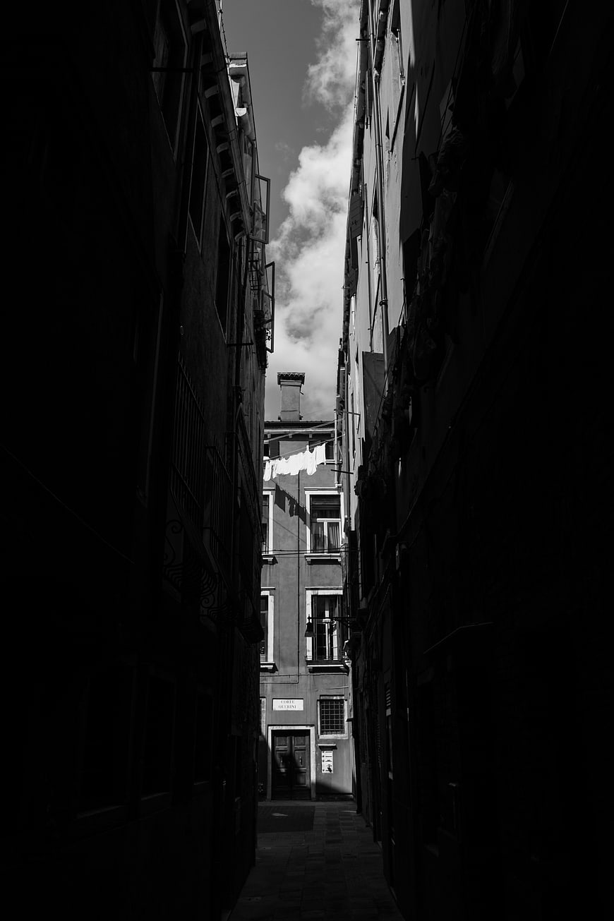 Dramatic black and white narrow alley in Venice, Italy