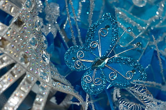 Close-up of blue glitter butterfly and silver snowflake ornament