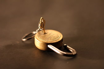 Unlocked Brass Padlock With Key On Dark Surface