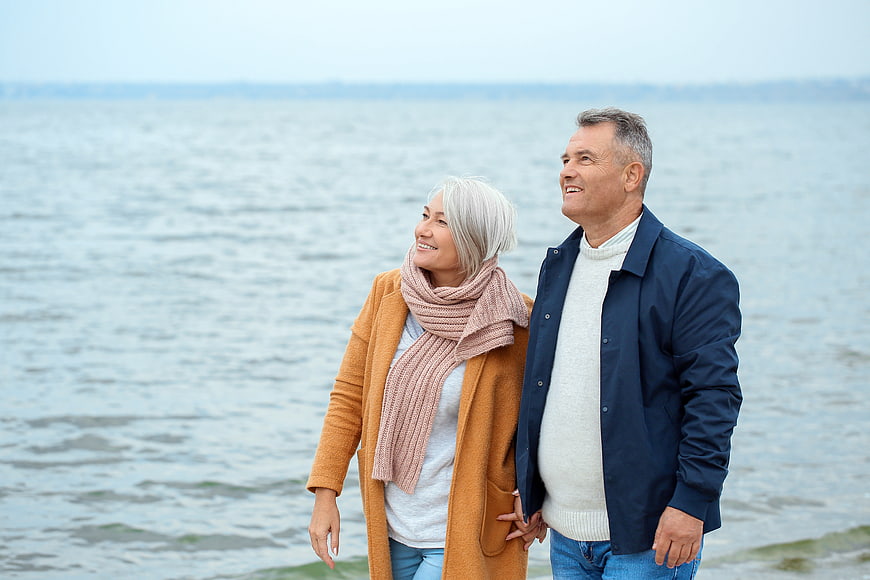 Happy Senior Couple Walking by the Sea