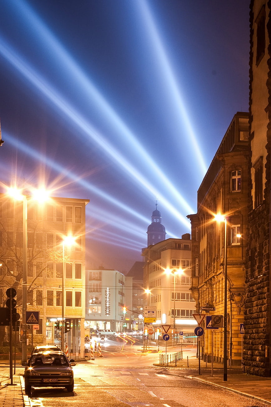 Blue Light Beams Over Frankfurt Street at Night