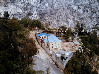 Aerial View of White Church with Blue Roof in Mountain Valley