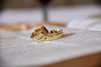 Gold wedding rings on an open bible page