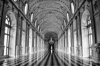 Black and white grand hall with checkered floor and ornate ceiling