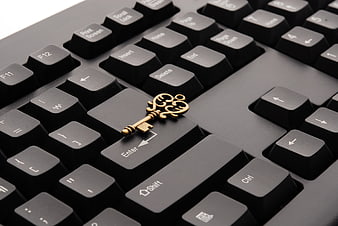 Vintage Brass Key on Black Computer Keyboard Enter Key