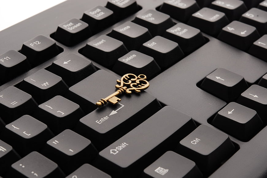 Vintage Brass Key on Black Computer Keyboard Enter Key