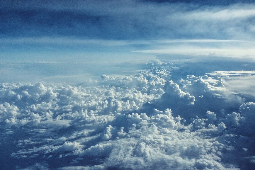 Aerial View of Fluffy White Clouds Against Blue Sky