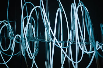 Abstract Blue Neon Light Sculpture on Black Background