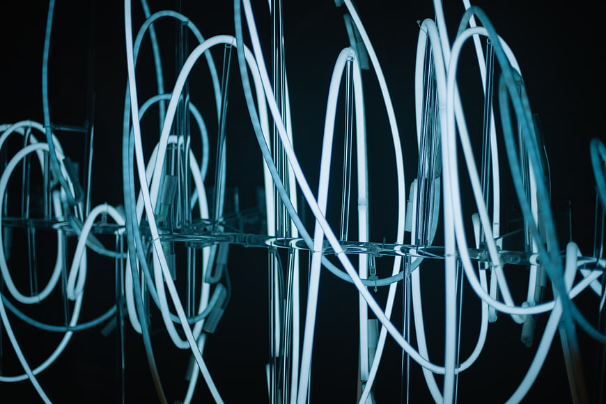 Abstract Blue Neon Light Sculpture on Black Background