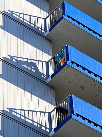 Modern Apartment Balconies with Blue Accents and Shadows