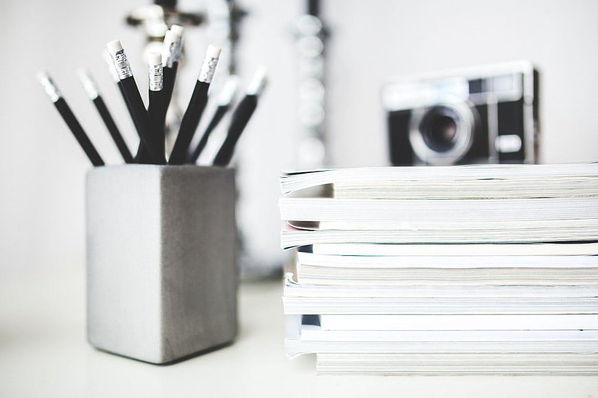 Minimalist Desk Setup with Pencils and Magazines