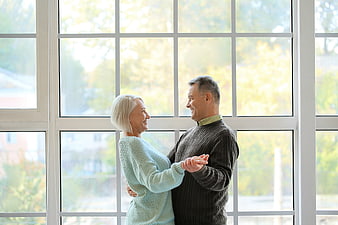 Happy Senior Couple Dancing Together Indoors