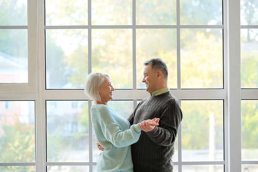 Happy Senior Couple Dancing Together Indoors