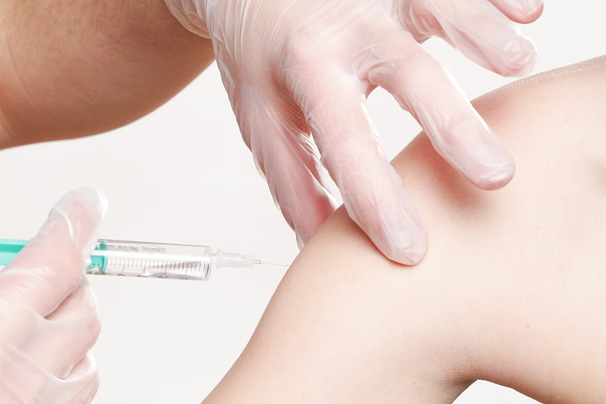 Close-up of medical injection into patient's arm
