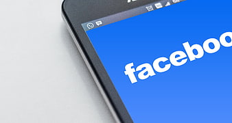 Close-up of Facebook logo on smartphone screen
