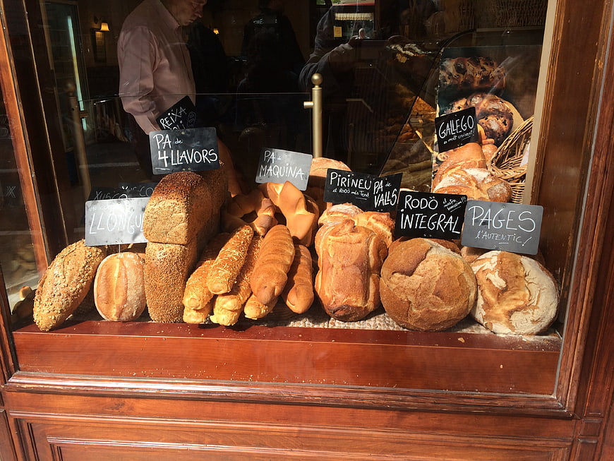 Artisan Bread Display In Bakery Window With Handwritten Signs