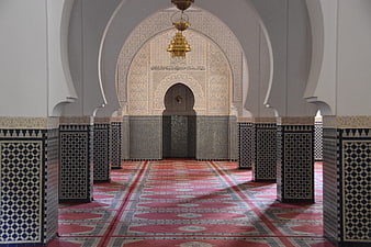 Interior of a Moroccan Mosque with Intricate Archway and Patterned Carpet