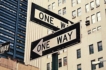 Contradictory One Way Street Signs in Urban Cityscape
