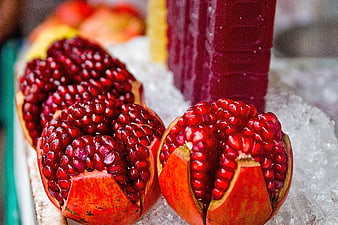 Fresh Pomegranates and Juice on Ice at Market