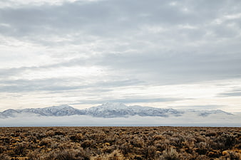 Snowy Mountain Range Overlooking Arid Desert Landscape