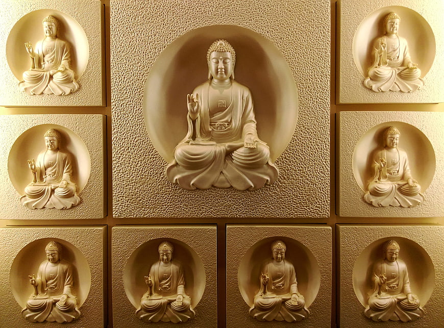 Decorative Wall Panel With Nine Buddha Statues In Gold And Beige Tones