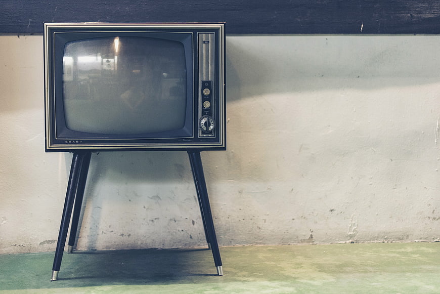 Vintage Sharp Television Set on Stand Against Wall