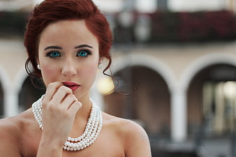 Portrait of Redhead Woman with Blue Eyes and Pearl Necklace
