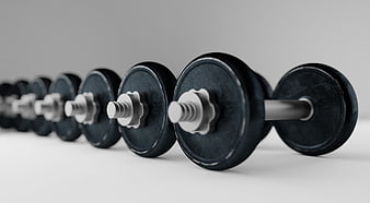 Row of Black Dumbbells on Gray Background