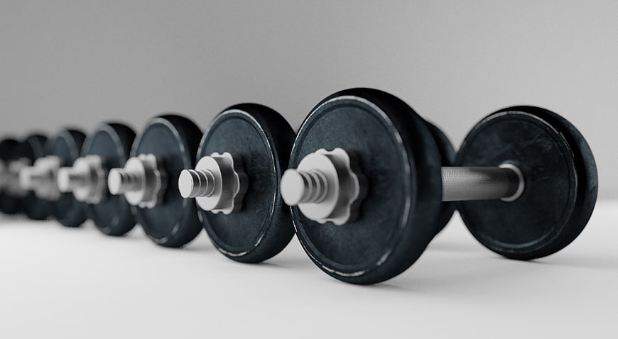 Row of Black Dumbbells on Gray Background
