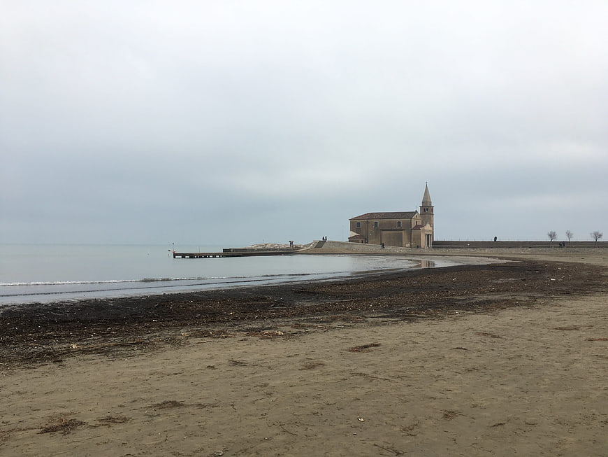Coastal Church on Sandy Beach Under Overcast Sky