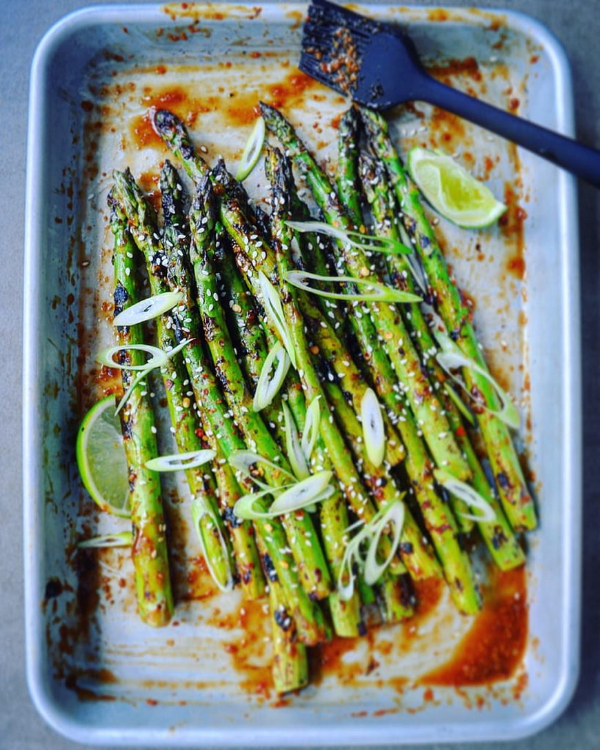 Grilled Asparagus with Lime and Sesame Seeds on Baking Sheet