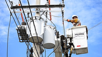 Electrician Working On High Voltage Transformer In Aerial Bucket