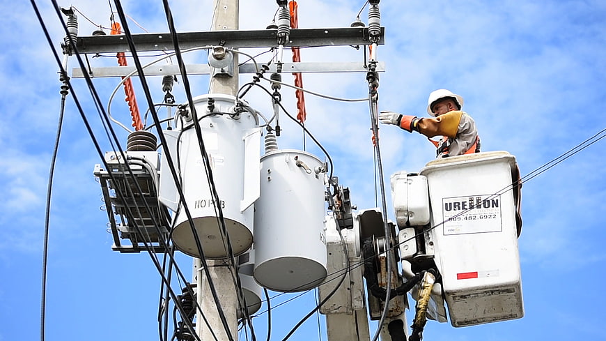 Electrician Working On High Voltage Transformer In Aerial Bucket