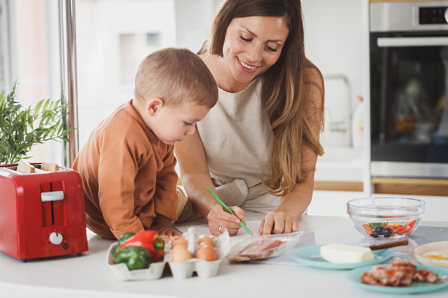 Mother and son planning healthy breakfast in kitchen