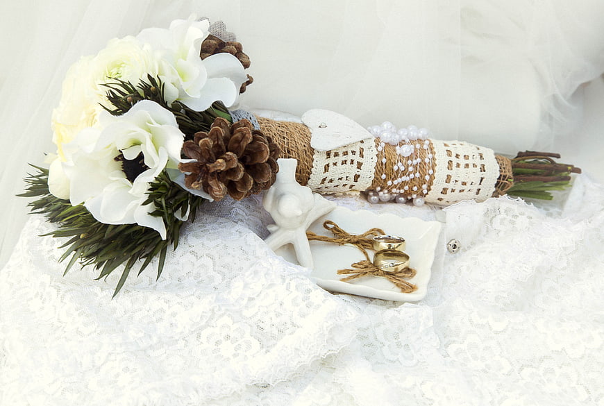 Rustic Wedding Bouquet With Pinecones, Lace, And Gold Rings