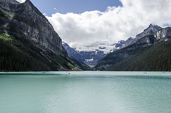 Turquoise Mountain Lake with Canoeists and Glacier