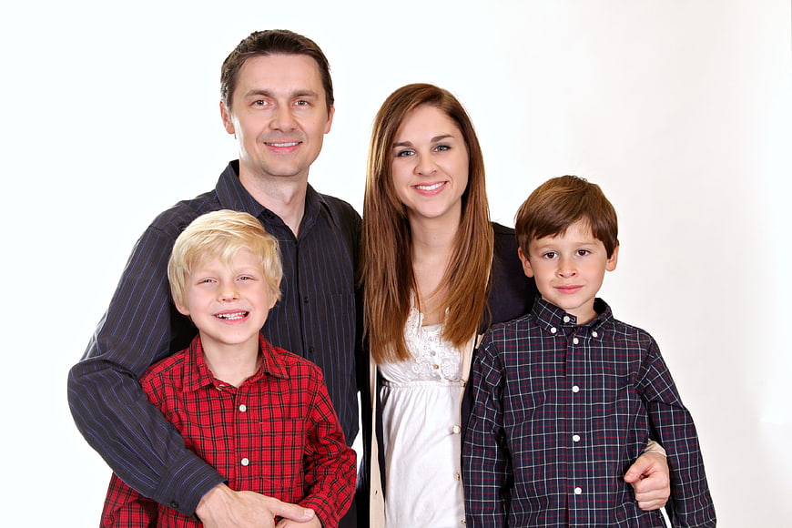 Happy family portrait with two parents and two young boys