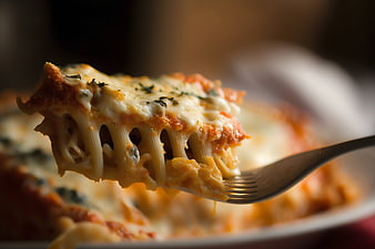 Close-up of cheesy lasagna on a fork