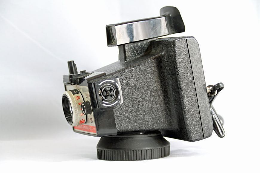 Vintage Polaroid SX-70 Camera on White Background