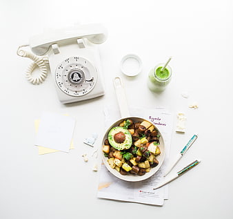 Flat lay of healthy breakfast with vintage rotary phone and green smoothie